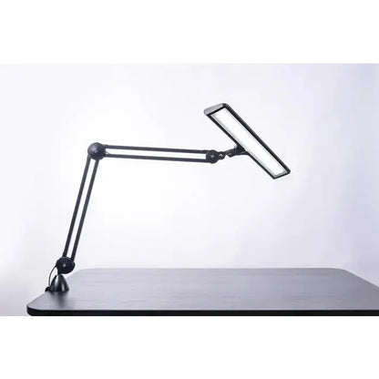 Side view of Daylight UnoPro lamp with ergonomic design

Daylight DN1450 UnoPro lamp in a modern home office setup

LED light head of UnoPro Table Lamp angled for close-up tasks

